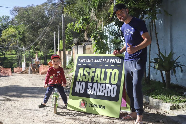 Obras do programa Asfalto no Saibro, no bairro Lamenha Pequena. Na imagem, os moradores Junior Kozovski e seu filho Gabriel. Foto: José Fernando Ogura/SMCS.